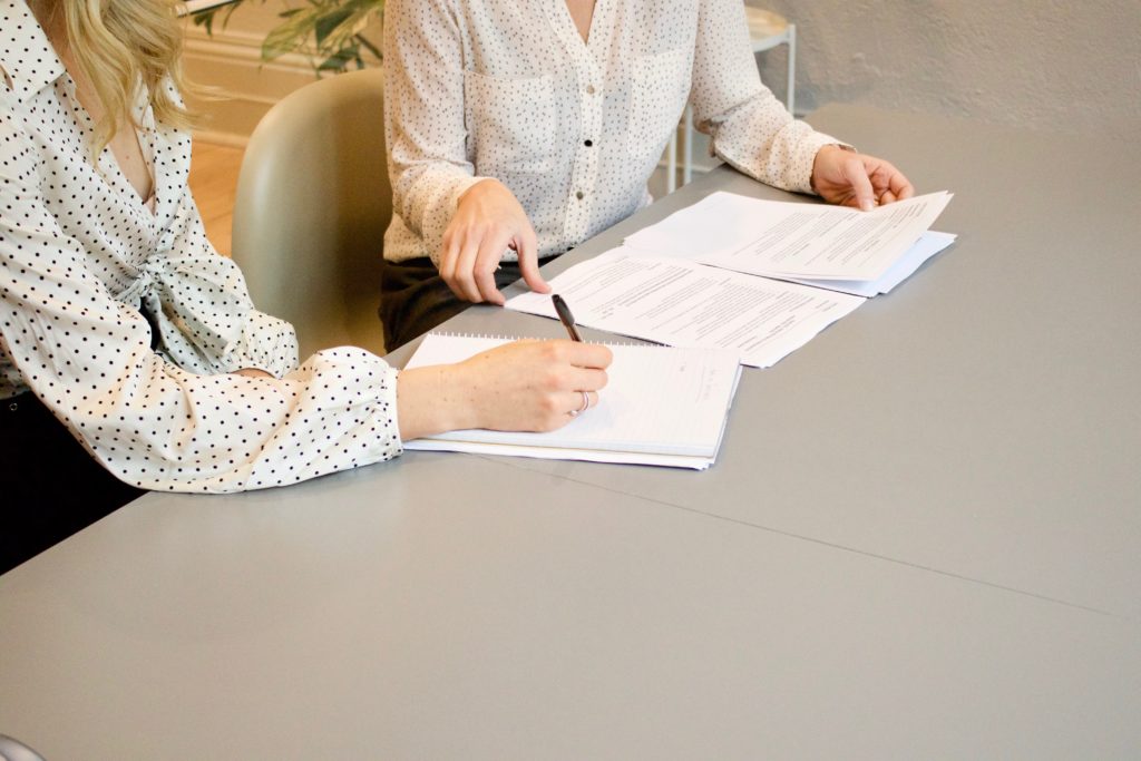 Colleagues at a table, reviewing a plan together.
