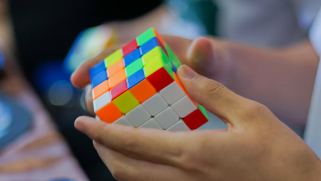 Person working on a challenging rubix cube.