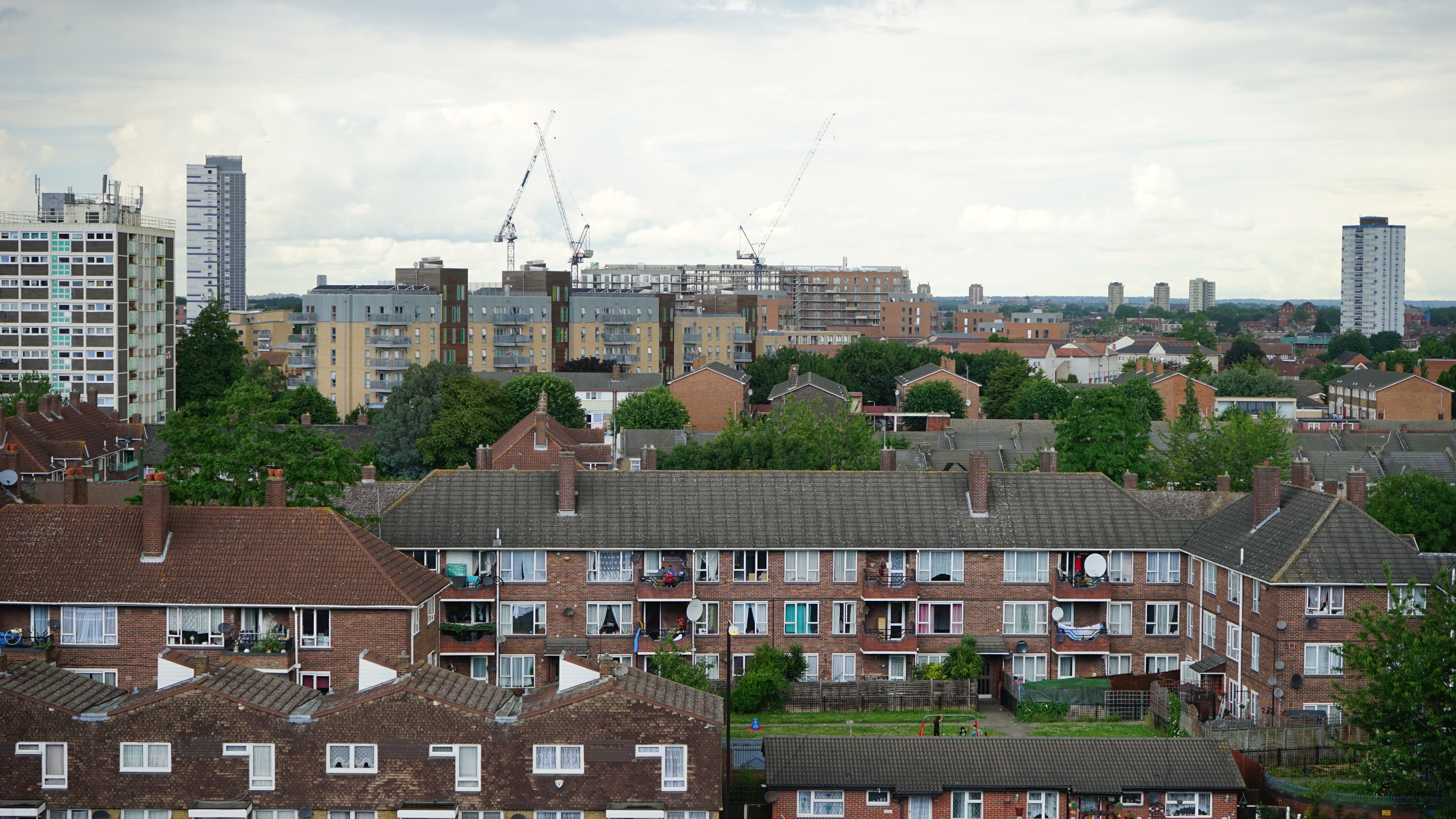 A photo showing tall buildings and apartments in a city.