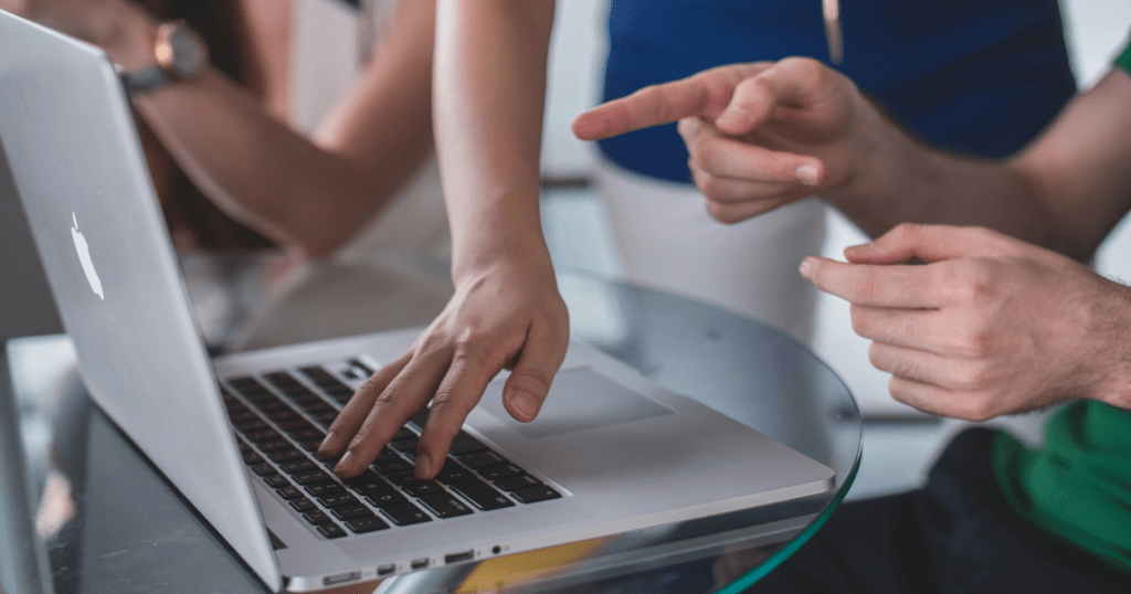 Image showing a team interacting with stakeholder software on a laptop.